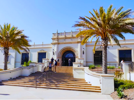 This is an image of people walking down steps at the entrance of the Copley Library on the University of San Diego Campus.